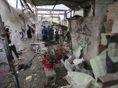 Citizens inspect the scene after a car bomb explosion at a crowded outdoor market in the Iraqi capital's eastern district of Sadr City, Iraq, on Monday. AP
