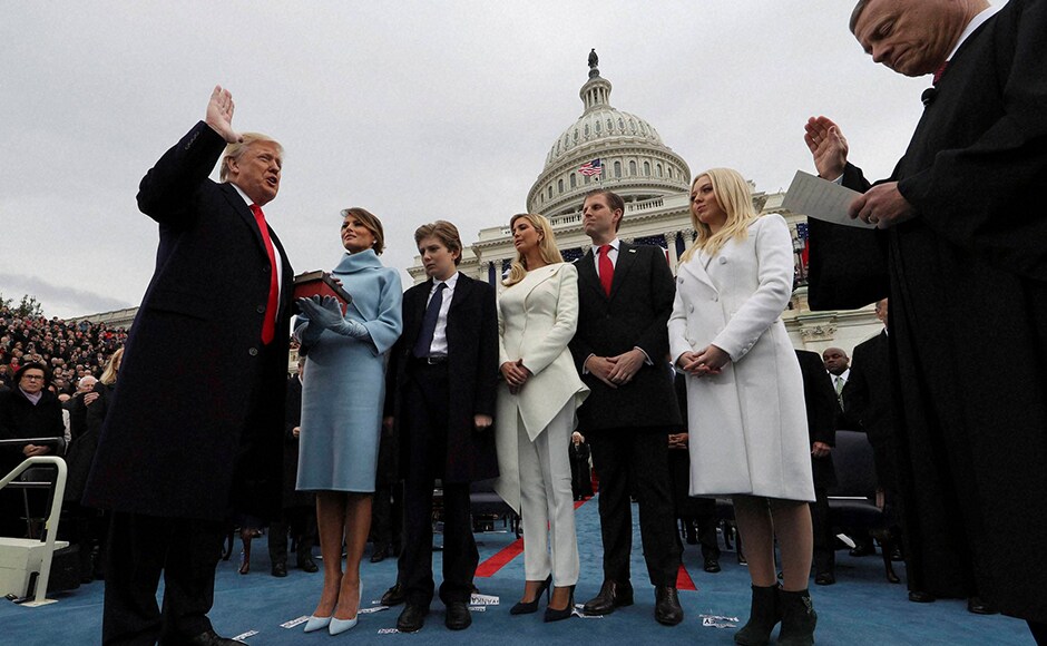 At Trump's side was his wife, Melania Trump donning a cashmere turtleneck dress that fell to her knee, paired with a cropped bolero jacket and matching suede gloves. AP At Trump's side was his wife, Melania Trump donning a cashmere turtleneck dress that fell to her knee, paired with a cropped bolero jacket and matching suede gloves. AP