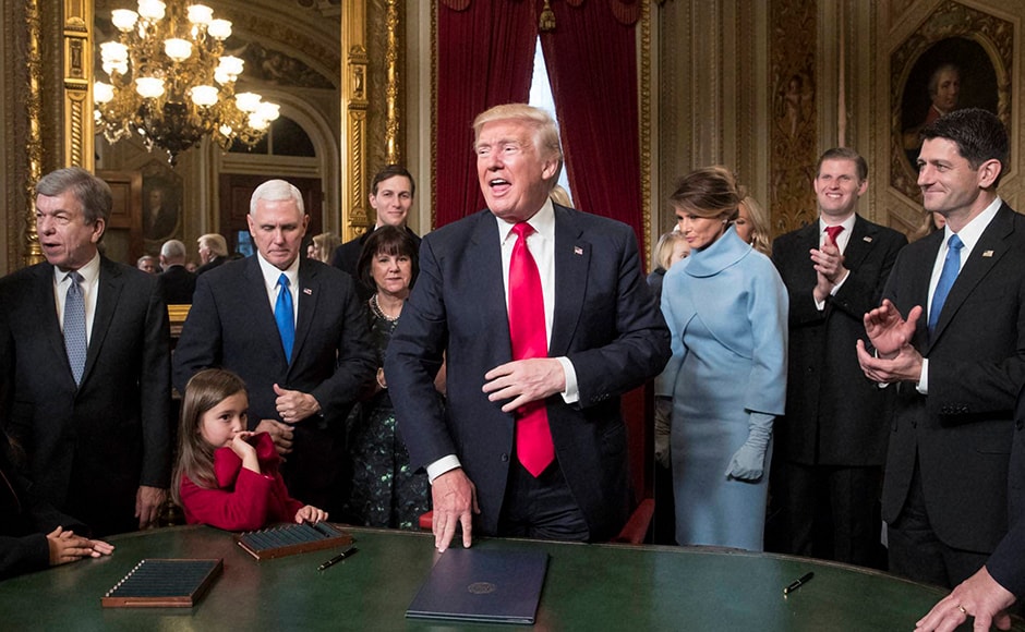 Joining him during the signing, from left, are Sen. Roy Blunt, Vice President Mike Pence and his wife Karen Pence, Jared Kushner, President Trump's wife Melania Trump, Eric Trump, and Speaker of the House Paul Ryan. Donald Trump has taken his first steps in office, signing an executive order aimed at health care reforms. Photo: AP Joining him during the signing, from left, are Sen. Roy Blunt, Vice President Mike Pence and his wife Karen Pence, Jared Kushner, President Trump's wife Melania Trump, Eric Trump, and Speaker of the House Paul Ryan. Donald Trump has taken his first steps in office, signing an executive order aimed at health care reforms. Photo: AP