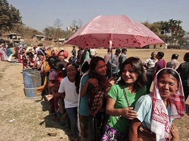 A woman shields herself from the sun with an umbrella. Nagaland went to polls to elect members to the state assembly. REUTERS
