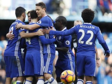 Chelsea's Cesc Fabregas is mobbed by his teammates after scoring against Arsenal. AP