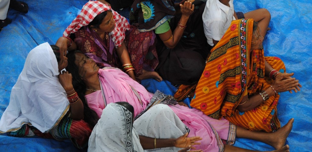 ANGRY VILLAGERS AT THE SITE OF THE BROKEN TEMPLE. THE WOMAN IN PINK SARI FAINTED SEVERAL TIMES, CLAIMING THAT THE GODDESS OF THE TEMPLE WAS SPEAKING THROUGH HER.