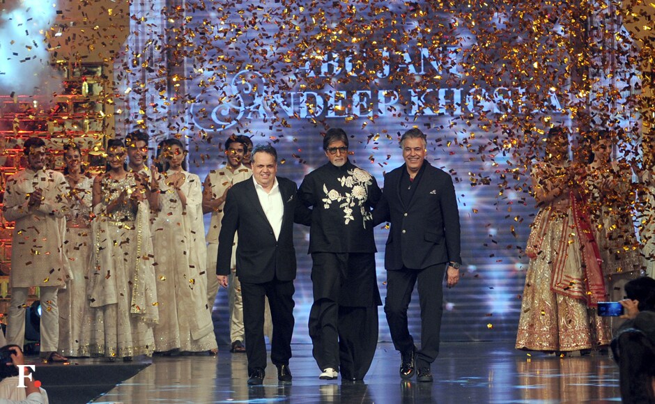The fashion designers, Abu Jani and Sandeep Khosla, accompany the showstopper Amitabh Bachchan on the ramp. Sachin Gokhale/Firstpost The fashion designers, Abu Jani and Sandeep Khosla, accompany the showstopper Amitabh Bachchan on the ramp. Sachin Gokhale/Firstpost