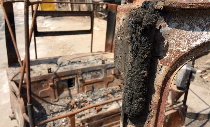 The auto that was set ablaze by an unidentified woman in police clothing and a covered face. Divya Karthikeyan