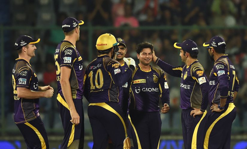 Kolkata Knight Riders captain Gautam Gambhir congratulates teammate Kuldeep Yadav for a wicket during the IPL. AFP