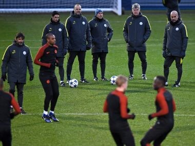 Manchester City's Pep Guardiola and players during a training session. AFP