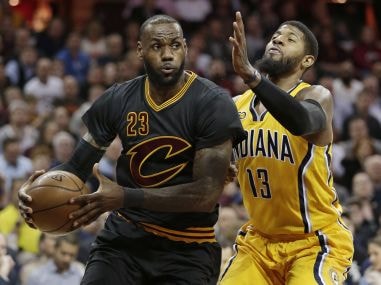 Cleveland Cavaliers LeBron James drives against Indiana Pacers' Paul George. AP