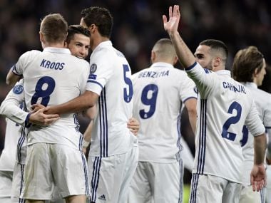 Real Madrid's teammates celebrate their third goal vs SSC Napoli in the Champions League. AFP