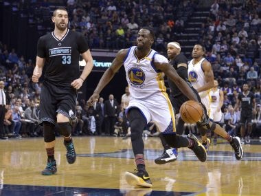 Golden State Warriors' Draymond Green drives the ball on a fast break past Memphis Grizzlies players. AP