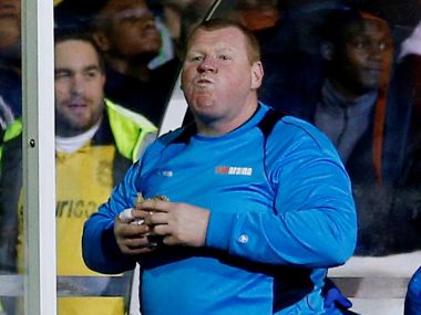 Sutton United's substitute Wayne Shaw eats a pie during the FA Cup match. Reuters