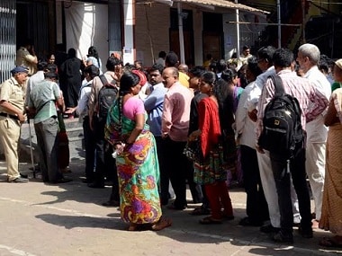 Voters queue up at a polling booth in Mumbai