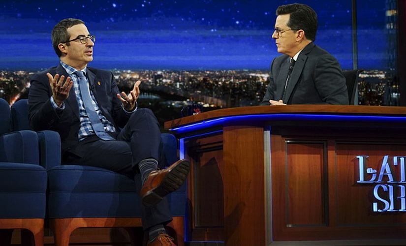 Stephen Colbert with John Oliver. Getty Images