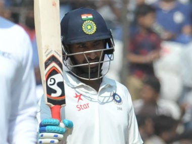 Pujara raises his bat after scoring a half-century on Day 4 of the one-off Test against Bangladesh. AFP