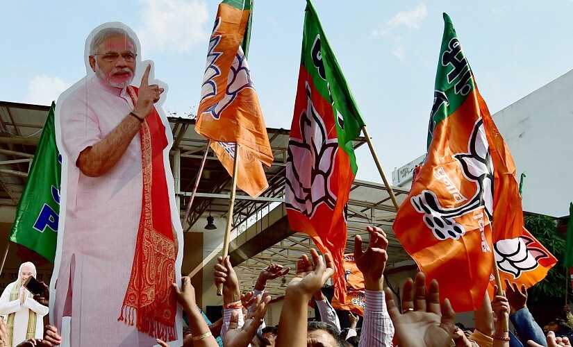 BJP workers carry a giant cut-out of Prime Minister Narendra Modi as they celebrate the partys victory in the UP. PTI