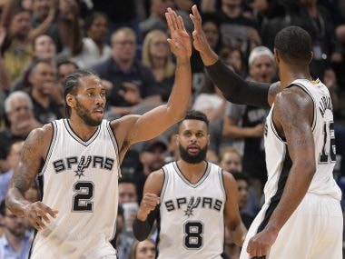 San Antonio Spurs forward Kawhi Leonard (2) celebrates a basket with teammates. AP
