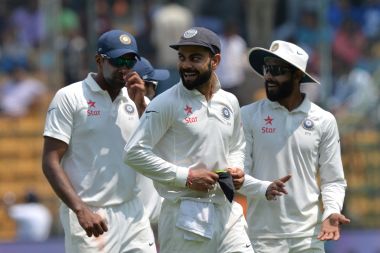 India captain Virat Kohli (centre) smiles during lunch break on the second day of the second Test. AFP