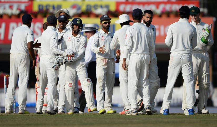 Indian team players shake hands with each other after the fifth day of the Ranchi Test. AP