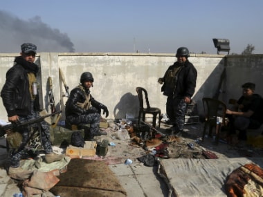 Soldiers take combat positions as Iraqi security forces advance during fighting against IS militants in western Mosul, Iraq. AP