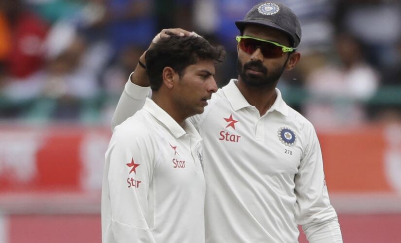India's Ajinkya Rahane, right, pats Kuldeep Yadav on the head during the match in Dharmsala. AP Photo