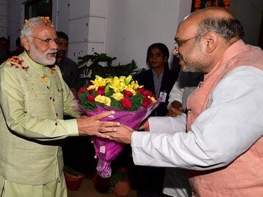 New Delhi: Prime Minister Narendra Modi being welcomed by party president Amit Shah at the party headquarters to celebrate victory in UP and Uttrakhand Assembly elections, in New Delhi on Sunday. PTI