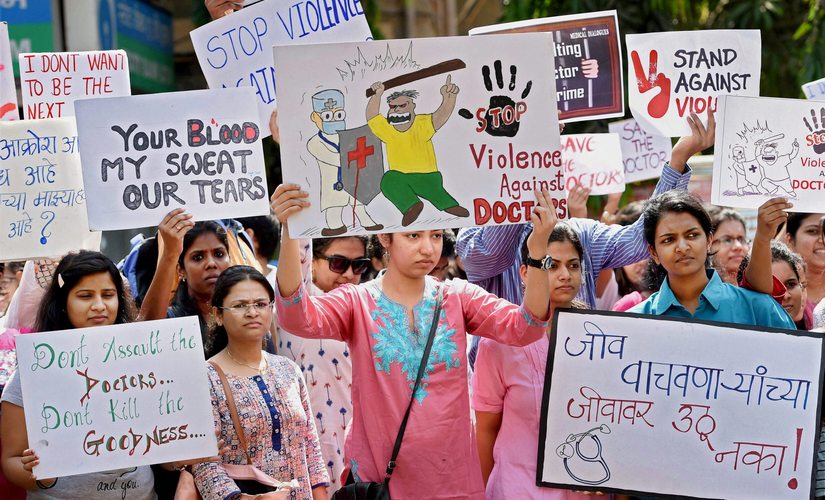 Resident doctors display placards during a protest rally at the KEM hospital in Mumbai. PTI