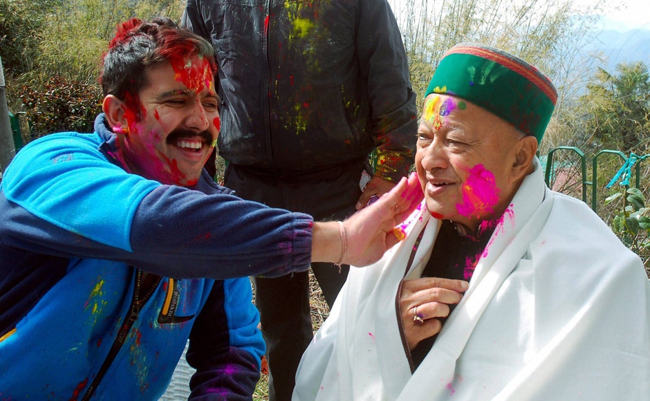 Shimla : Himachal Pradesh Chief Minister Virbhadra Singh celebrating Holi festival with his son in Shimla on Monday. PTI Shimla : Himachal Pradesh Chief Minister Virbhadra Singh celebrating Holi festival with his son in Shimla on Monday. PTI