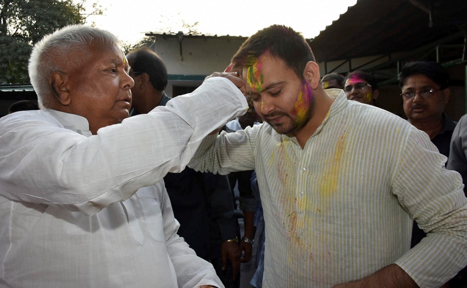 Patna: RJD Chief Lalu Prasad with his son and Bihar deputy CM Tejashwi Yadav during Holi celebrations in Patna on Monday. PTI Patna: RJD Chief Lalu Prasad with his son and Bihar deputy CM Tejashwi Yadav during Holi celebrations in Patna on Monday. PTI