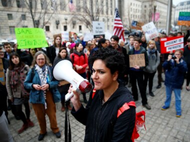 Immigration activists rally against the Trump administration's new Travel ban in Washington. Reuters