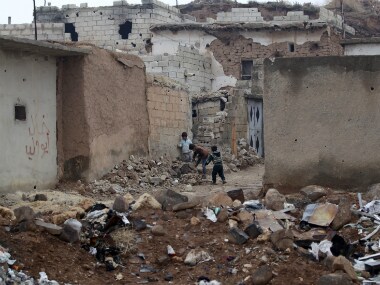 Children play near rubble of damaged buildings in northern Aleppo countryside, Syria. Reuters