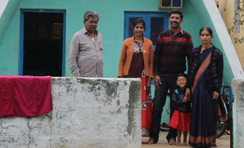 Thorthai Goodn, with his family in front of their traditionally shaped house. Firstpost/Sibi Arasu