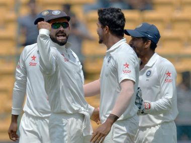 Virat Kohli (left) celebrates the dismissal of Steve Smith during the second Test. AFP