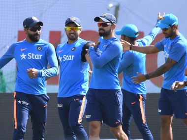 Virat Kohli warms up with teammates during a training session in Dharamsala. AFP