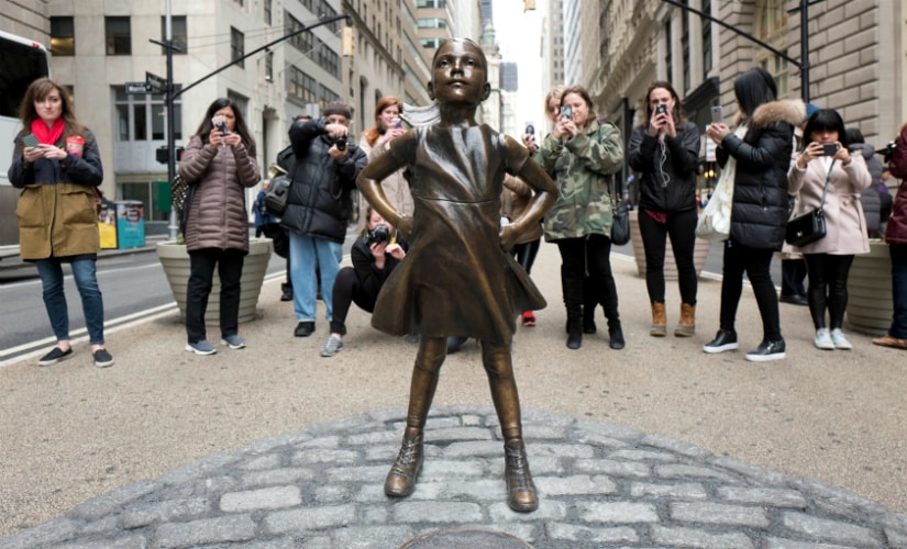 Fearless girl stares down the charging bull, as an equal opponent. AP