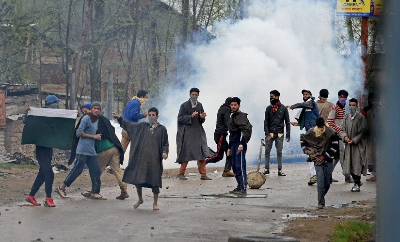 A group of youth pelting stones on security forces during an anti-militant operation at village Durbugh in Chadoora area of central Kashmir's Budgam district on Tuesday. PTI