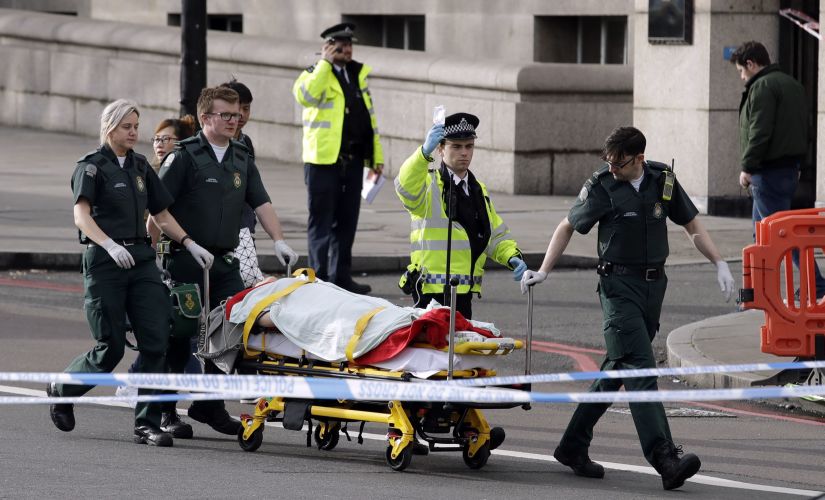 Emergency services staff provide medical attention close to the Houses of Parliament in London on Wednesday. AP