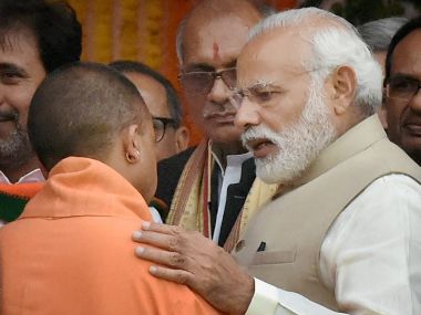 Prime Minister Narendra Modi speaks with UP Chief Minister Yogi Adityanath after the swearing-in ceremony in Lucknow on Sunday. PTI