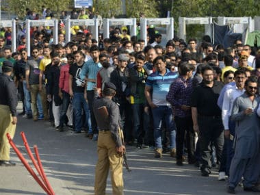 Spectators queue up at one of entry gates of the Gaddafi Stadium for the PSL 2017 held amid huge security. AFP