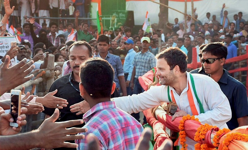 Rahul Gandhi reaching out to his supporters during a rally. PTI