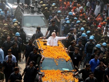 Varanasi: Prime Minister Narendra Modi greets crowd at a road show in Varanasi on Saturday. PTI Photo (PTI3_4_2017_000051B)