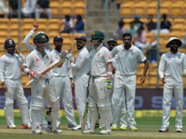 Steve Smith, (C) David Warner and the Indian team wait for the third umpire's decision ion Day 4 of the Bengaluru Test between India and Australia. AFP