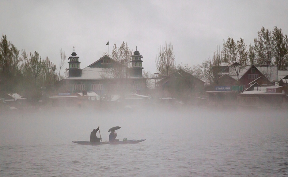 Kashmiri men ride a boat on the Dal Lake amid dense fog after fresh snowfall in Srinagar, Indian-controlled Kashmir on Thursday. Heavy snowfall and rains have forced authorities in Indian-controlled Kashmir to close schools and colleges even as the only all weather road link that connects the Kashmir valley to the rest of India has been cut off. (AP Photo/Dar Yasin) Kashmiri men ride a boat on the Dal Lake amid dense fog after fresh snowfall in Srinagar, Indian-controlled Kashmir on Thursday. Heavy snowfall and rains have forced authorities in Indian-controlled Kashmir to close schools and colleges even as the only all weather road link that connects the Kashmir valley to the rest of India has been cut off. (AP Photo/Dar Yasin)