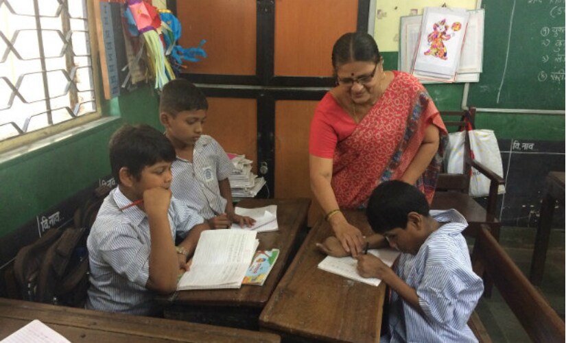 Javed Shaikh with his class teacher, Charulata Patil, in the Jagannath Bhatankar Municipal Corporation School, Parel, Mumbai. IndiaSpend