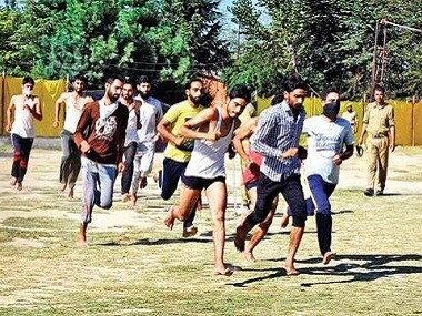 Kashmiri youth run during an army recruitment rally. PTI
