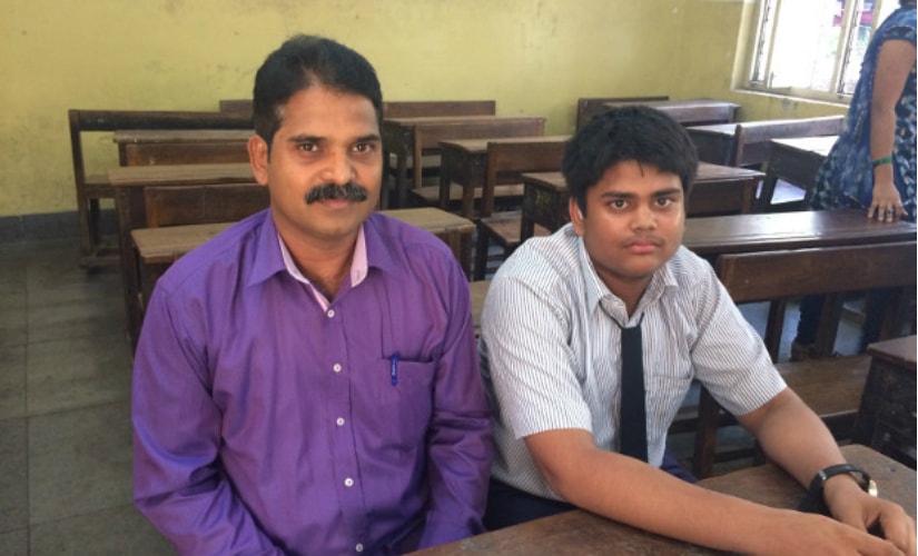 Deepak Khedekar with his son, Sahil, who suffers from hearing impairment and studies in grade VIII at the Baradevi Municipal School, in Sewri, Mumbai. IndiaSpend