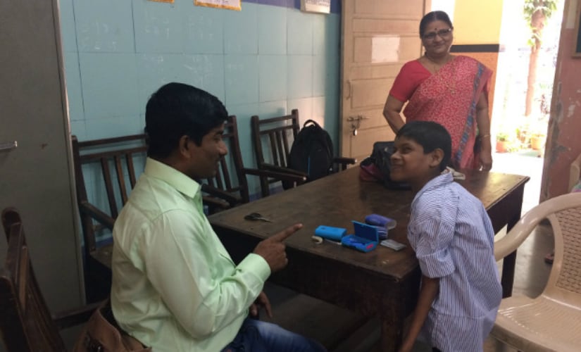 Sunil Bhadane, special educator, Sarva Shiksha Abhiyan, with Javed Shaikh whom he spotted four years ago. Bhadane earns Rs 20,000 per month–based on an allowance per child–and works six days a week. IndiaSpend