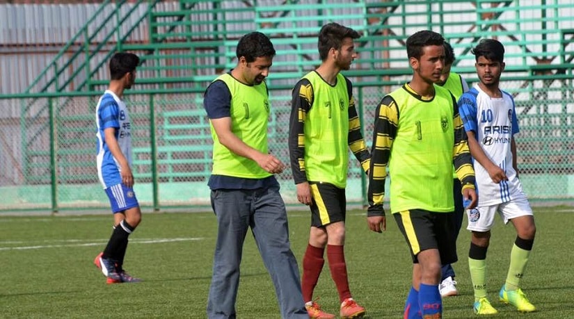 Tassaduq Hussain Mufti (second from left) was recently seen playing football with youngsters in Srinagar, Kashmir. Image source: PDP
