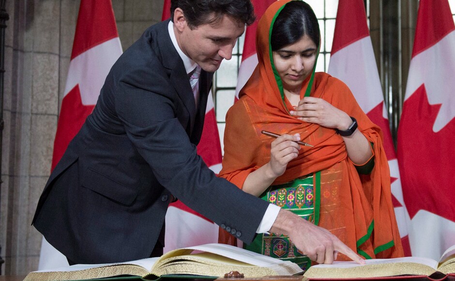 Prime Minister Justin Trudeau shows Malala Yousafzai the guest book after arriving on Parliament Hill for her Honorary Canadian Citizenship ceremony in Ottawa on Wednesday. AP Prime Minister Justin Trudeau shows Malala Yousafzai the guest book after arriving on Parliament Hill for her Honorary Canadian Citizenship ceremony in Ottawa on Wednesday. AP