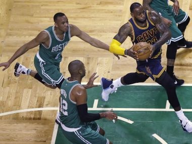 Cleveland Cavaliers forward LeBron James (23) drives to the basket past Boston Celtics players. AP