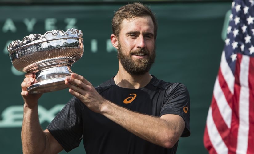Steve Johnson shows off the championship trophy after dfeating Thomaz Bellucci in the final. AP