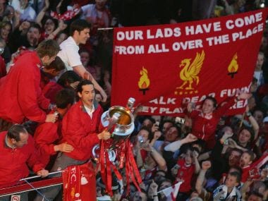 Luis Garcia lifts the Champions League trophy as the Liverpool team ride on an open top bus. Getty Images